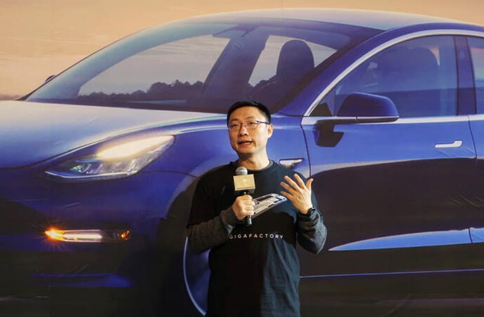 FILE PHOTO: Tesla's China chief Tom Zhu speaks at a delivery ceremony for China made Tesla Model 3 vehicles in the Shanghai Gigafactory of the U.S. electric car maker in Shanghai
